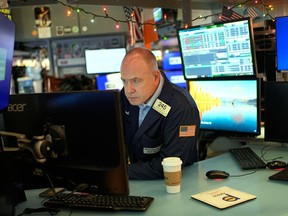 Derek Orth works on the floor at the New York Stock Exchange in New York, Wednesday, Dec. 10, 2025.