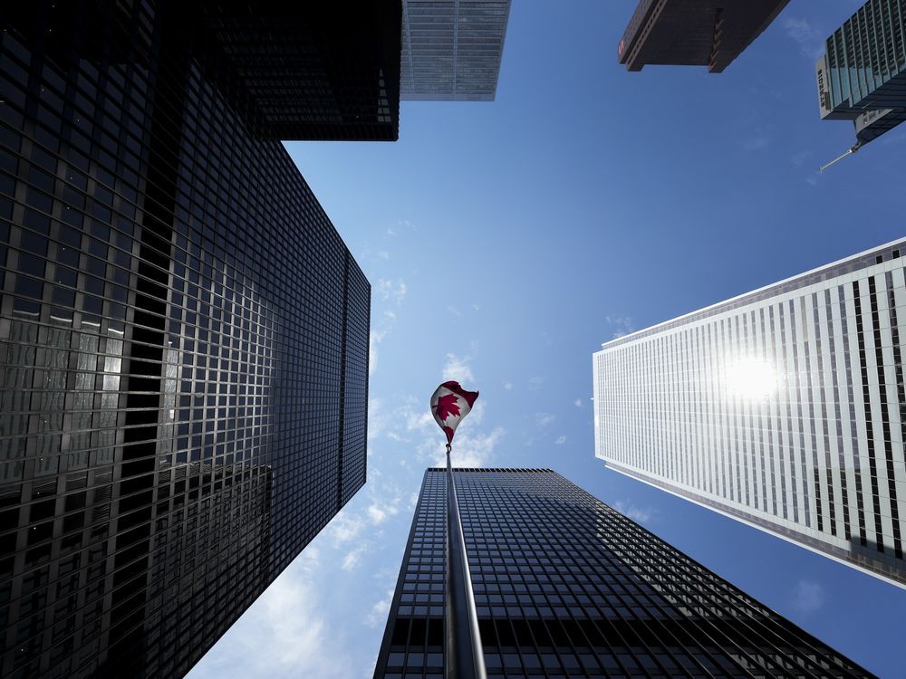The Bay Street Financial District is shown with the Canadian flag in Toronto on Friday, Aug. 5, 2022.THE CANADIAN PRESS/Nathan Denette