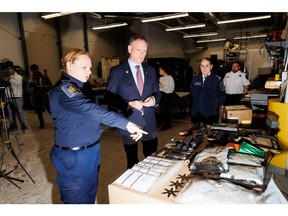 Cabinet minister David McGuinty, center, then Canada's minister of public safety, looks at confiscated items during a tour of a Canada Border Services Agency commercial air cargo facility in February. Canada has ramped up its fight against fentanyl since Donald Trump returned to the White House.