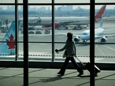 A traveller passes Air Canada planes at Pearson International Airport in Toronto.