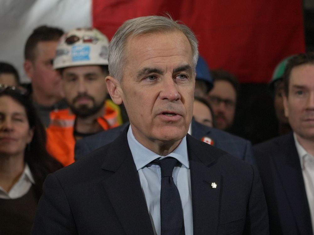 Prime Minister Mark Carney talks to reporters after a meeting in Calgary on Nov. 27.
