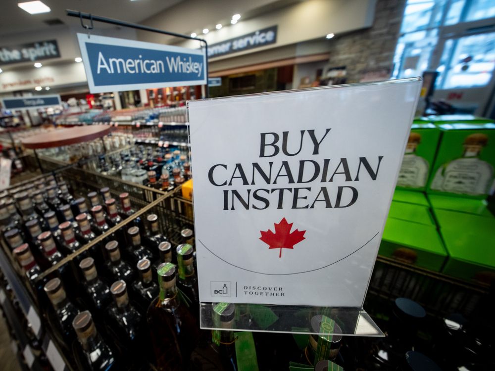 A sign is placed in front of the American whiskey section at a B.C. liquor store after top selling American made products have been removed from shelves in Vancouver.