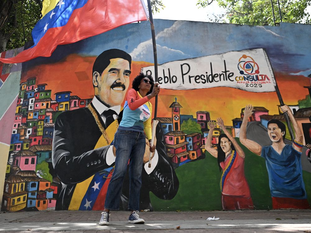 A supporter of ousted Venezuela's President Nicolas Maduro waves a Venezuelan national flag during a rally near the National Assembly in Caracas on Jan. 5, 2026.