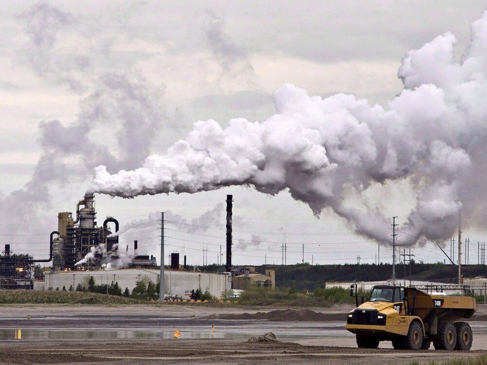 A dump truck works near the Syncrude oil sands extraction facility near the city of Fort McMurray, Alberta on Sunday June 1, 2014.