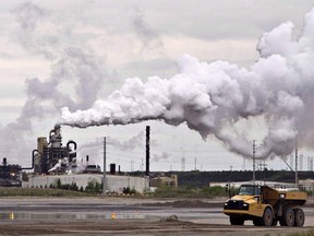 A dump truck works near the Syncrude oil sands extraction facility near the city of Fort McMurray, Alberta on Sunday June 1, 2014.