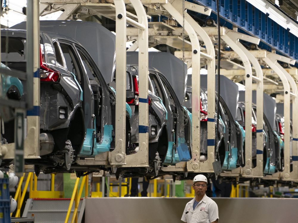 An autoworker stands on the vehicle assembly line at Canada Manufacturing Plant 2 in Alliston, Ontario.