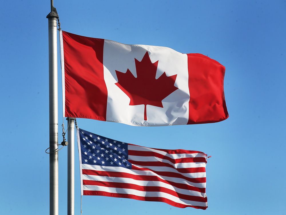 A Canadian and an American flag are shown in Windsor, Ontario.