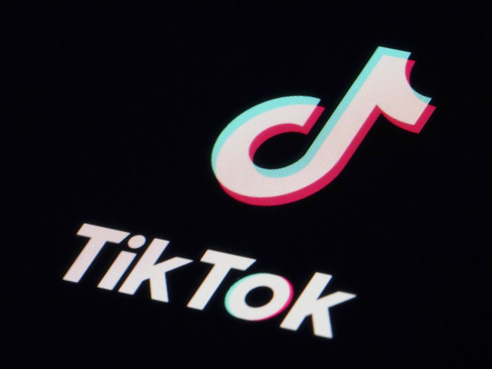 The logo of the social media app TikTok in white, with 3D highlights of red and blue, on a black background