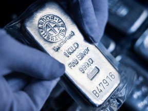An attendant holds a one kilogram silver bar at Conclude Zrt bullion dealer arranged in Budapest, Hungary, on Feb. 17, 2025.