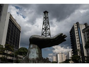 A sculpture of a hand holding an oil well outside Petroleos de Venezuela SA (PDVSA) headquarters in Caracas.