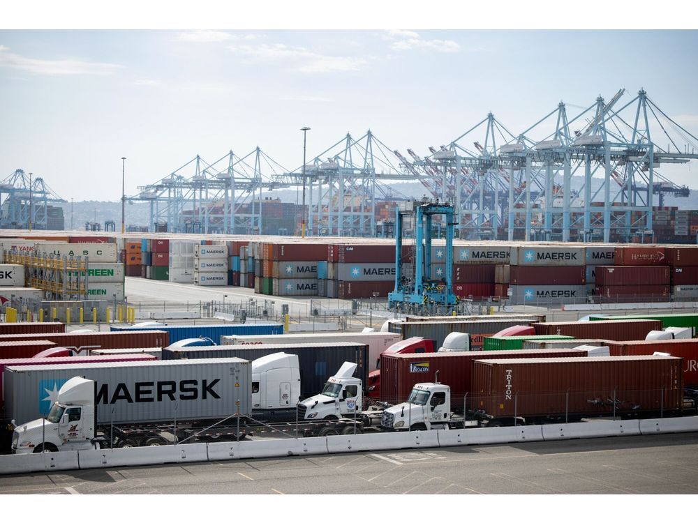 Tractor trailers carrying shipping containers at the Port of Los Angeles.