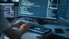 Close-up Focus on Person's Hands Typing on the Desktop Computer Backlit Keyboard. Screens Show Coding Language User Interface. Software Engineer Create Innovative e-Commerce App. Program Development