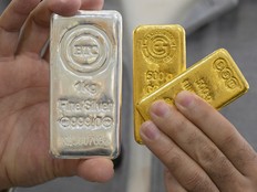 A jeweller shows gold and silver bars at his shop in downtown Kuwait City, Kuwait.
