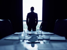 Businessman in office boardroom making up his mind before important meeting