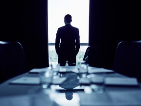 Businessman in office boardroom making up his mind before important meeting