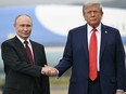 U.S. President Donald Trump greets Russian President Vladimir Putin on the tarmac after they arrived at Joint Base Elmendorf-Richardson in Anchorage, Alaska, on August 15, 2025.