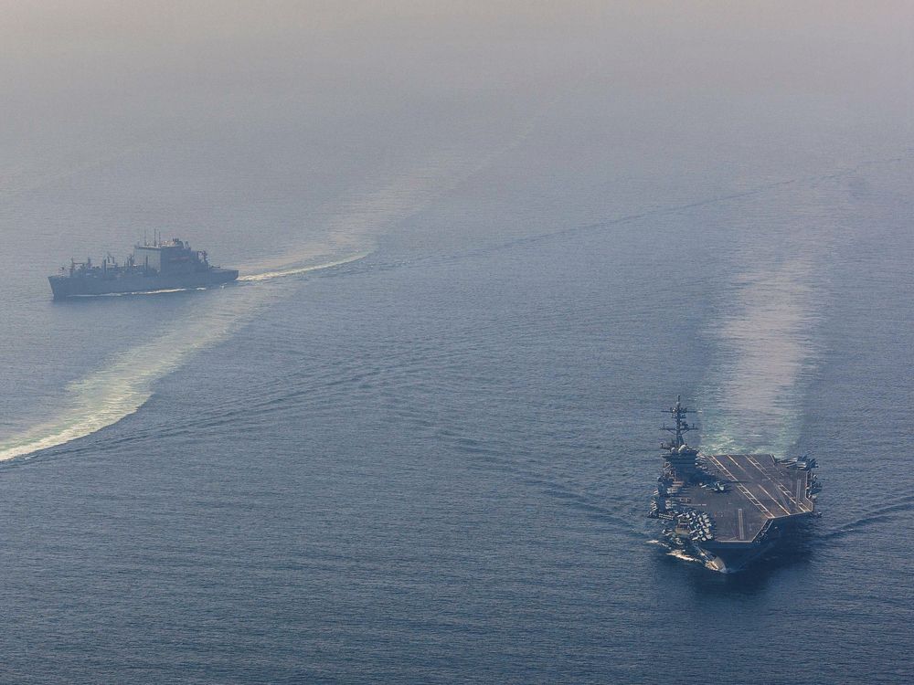 In this handout photograph released by the US Navy on February 6, 2026, Nimitz-class aircraft carrier USS Abraham Lincoln (CVN 72) sails alongside Arleigh Burke-class guided-missile destroyer USS Frank E. Petersen Jr. (DDG 121) and Lewis and Clark-class dry cargo ship USNS Carl Brashear (T-AKE 7) in the Arabian Sea, on February 6.
