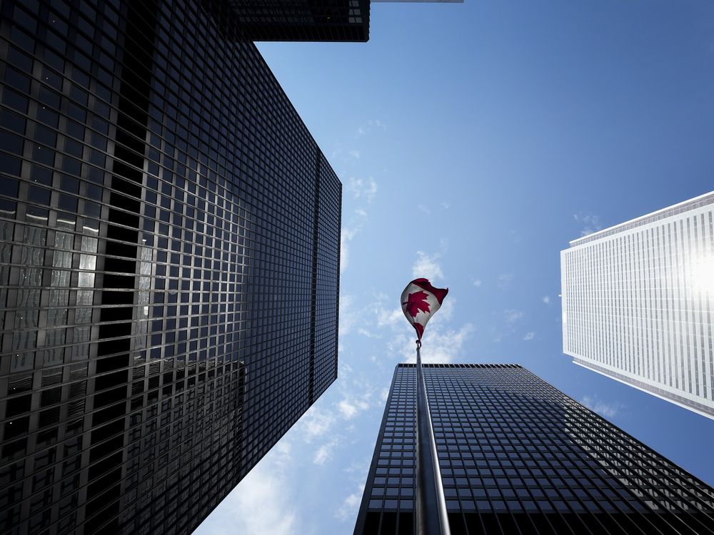 The Bay Street Financial District is shown with the Canadian flag in Toronto on Aug. 5, 2022.