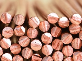 A close up of a stack of copper wire, manufactured for use in electric power cables.