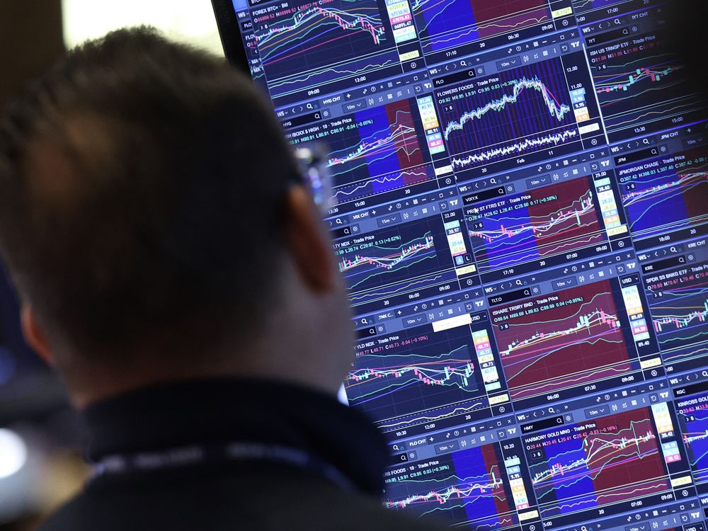 A trader works at the opening bell on the floor of the New York Stock Exchange (NYSE) in New York, on February 20, 2026