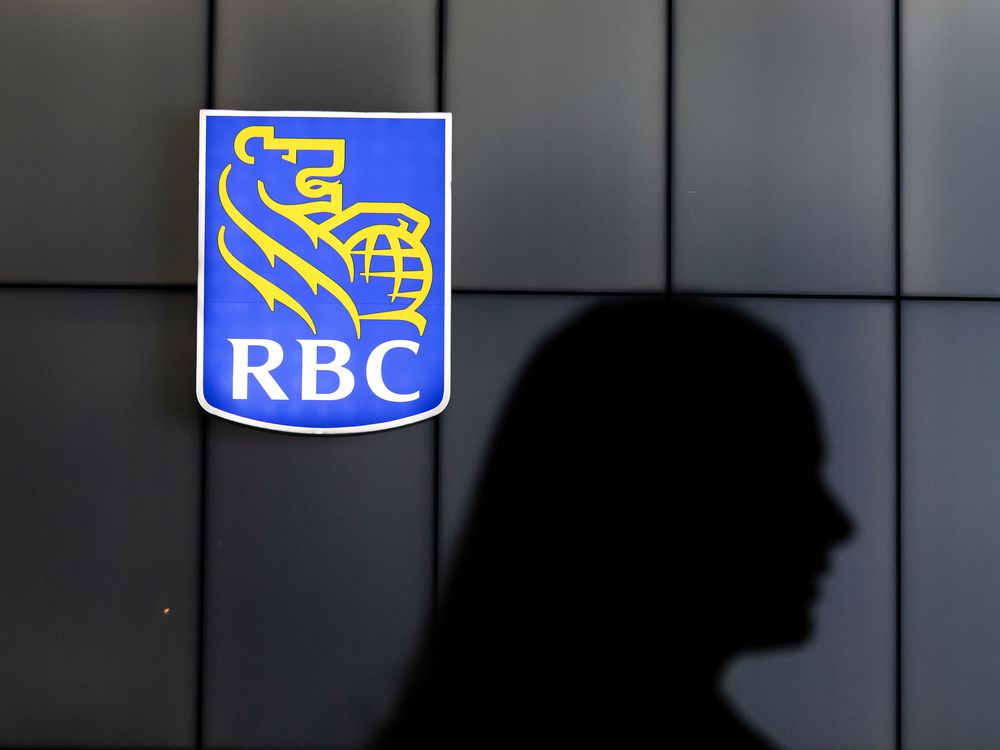 A pedestrian is silhouetted by a RBC Bank symbol on Toronto’s Front Street, Thursday January 8, 2026.
