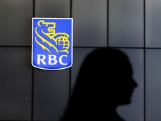 A pedestrian is silhouetted by a RBC Bank symbol on Toronto’s Front Street, Thursday January 8, 2026.