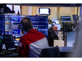 Traders work on the floor at the New York Stock Exchange.