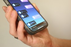 Hand holding smartphone with voice messages open in a chat app. Close-up of screen with audio messages, modern communication, messaging and mobile technology concept.