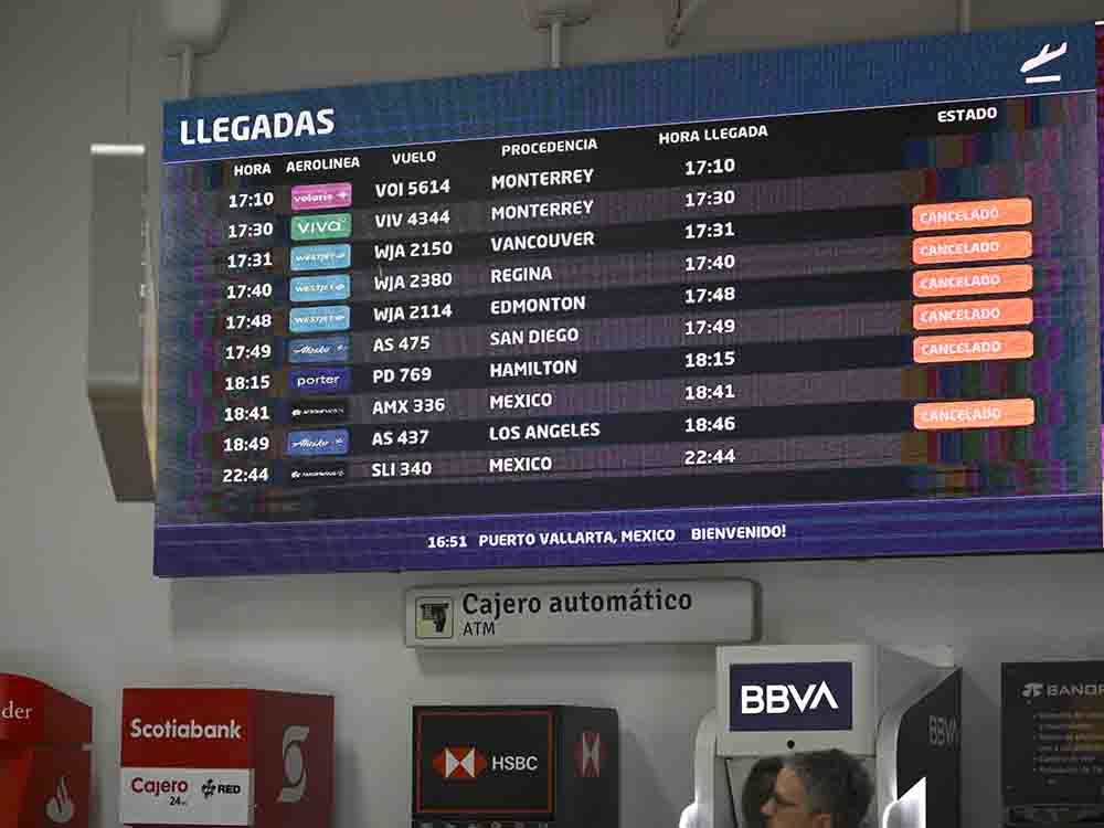 A screen indicates multiple cancelled flights to Licenciado Gustavo Diaz Ordaz International Airport in Puerto Vallarta, Jalisco state, Mexico, on Feb. 23, 2026.