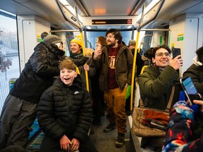 People ride the Eglinton Crosstown LRT on its first day of service in Toronto on Feb. 8.