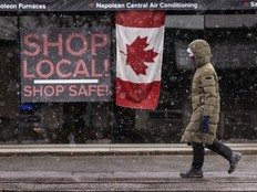 A person walks past signage stating “Shop Local! Shop Safe!” at a Napoleon barbecue location in Toronto, Ont.