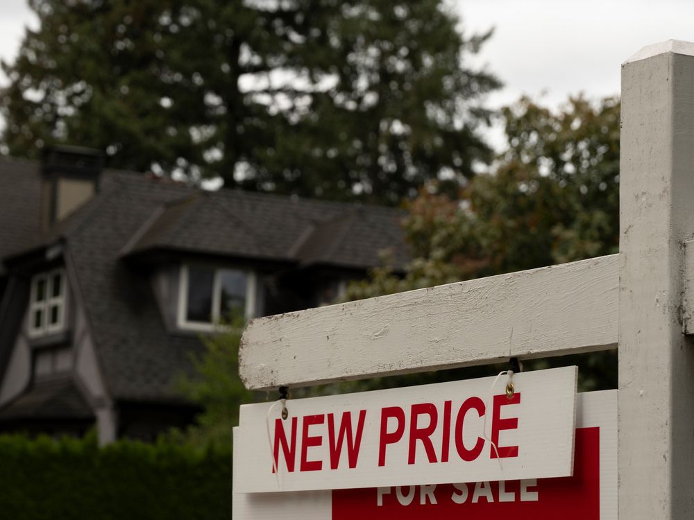 A 'new price' sign outside a home for sale in Vancouver, B.C.