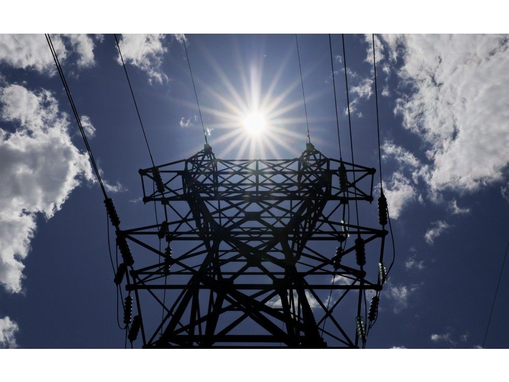 FOR FILER: A sunburst is seen over an electrical tower near the Tufts Cove Generating plant on Farrell Street in Dartmouth Wednesday May 28, 2025. FOR NOVA SCOTIA POWER FILERS TIM KROCHAK PHOTO