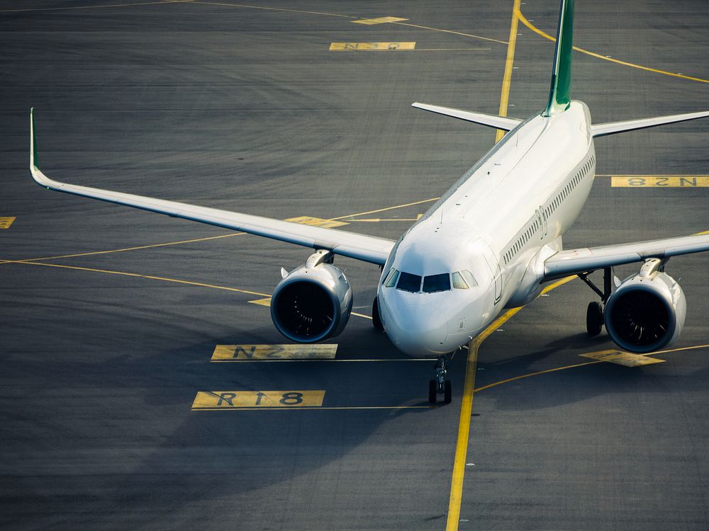 Commercial airplane during taxiing on taxiway to airport runway for take off.