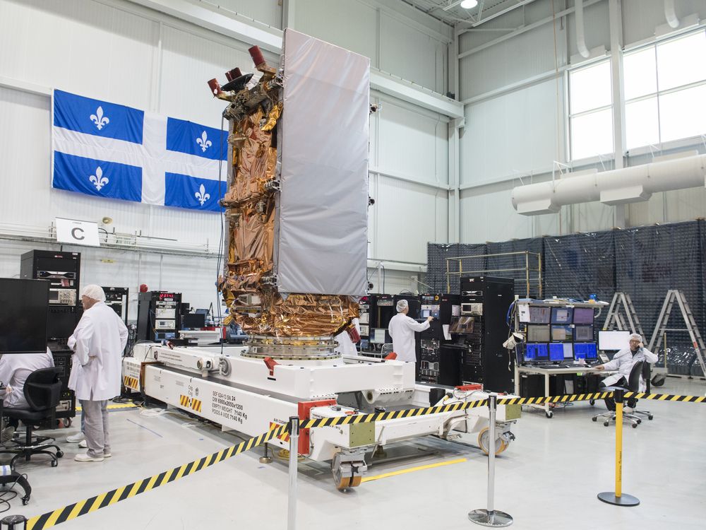 Engineers work on a RADARSAT Constellation satellite at MDA, Ste-Anne-de-Bellevue, west of Montreal, Friday, May 25, 2018.