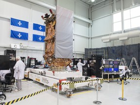 Engineers work on a RADARSAT Constellation satellite at MDA, Ste-Anne-de-Bellevue, west of Montreal, Friday, May 25, 2018.