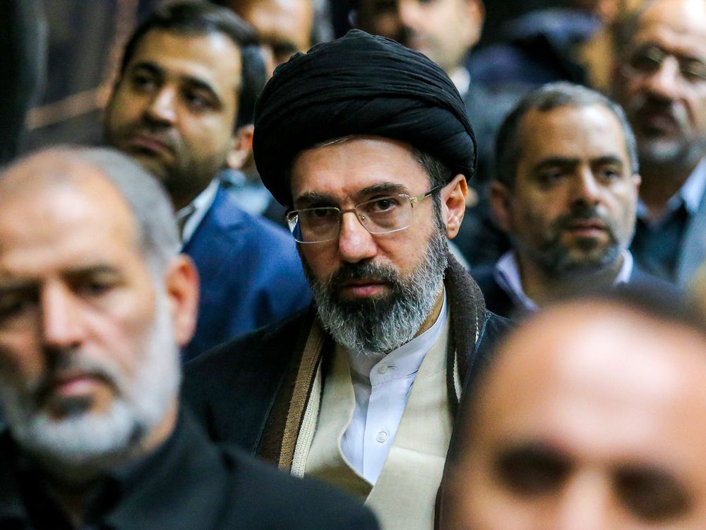 In this picture obtained from Iran's ISNA news agency, Mojtaba Khamenei (C), son of Iran's supreme leader Ayatollah Ali Khamenei, looks on during a gathering in Tehran