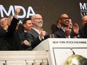 Mike Greenley, chief executive of MDA Space Ltd, celebrates after ringing the opening bell at the New York Stock Exchange during morning trading on March 12, 2026 in New York City.
