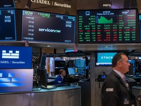 Traders work on the floor of the New York Stock Exchange (NYSE) on March 13, 2026 in New York City.