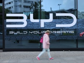 A woman walks past a dealership of Chinese electric car manufacturer BYD on May 23, 2025 in Berlin, Germany