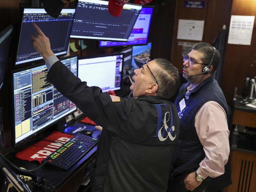 Traders work on the floor of the New York Stock Exchange (NYSE) at the opening bell in New York on March 18, 2026.