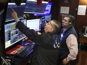 Traders work on the floor of the New York Stock Exchange (NYSE) at the opening bell in New York on March 18, 2026.