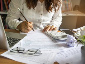 Budget planning concept. Accountant is calculating company's annual tax.