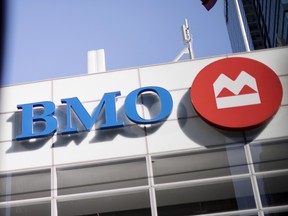 A Bank of Montreal (BMO) sign is reflected on a surface in the financial district of Toronto, Ontario, Canada