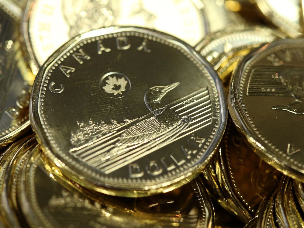 Canadian one dollar coins, also known as Loonies, sit in a pile at the Royal Canadian Mint Ltd. manufacturing facility in Winnipeg on March 11, 2019.
