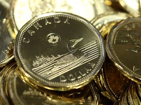 Canadian one dollar coins, also known as Loonies, sit in a pile at the Royal Canadian Mint Ltd. manufacturing facility in Winnipeg on March 11, 2019.