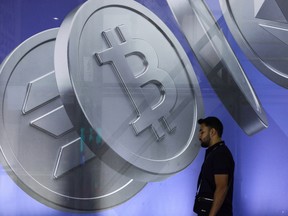 An image of Bitcoin and other cryptocurrency tokens displayed at the Token2049 conference in Singapore, on Wednesday, Oct. 1, 2025.