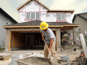 House builders work on constructing a residential house in Bellville, Ont.