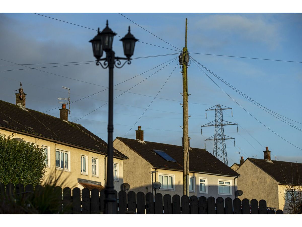 Electrical power lines hang from a transmission pylon among houses in Belfast, Northern Ireland, U.K., on Friday, Jan. 3, 2020. With the U.K. due to leave the European Union, questions remain over trading agreements and Ireland's 12-year-old single electricity market, known as the SEM.