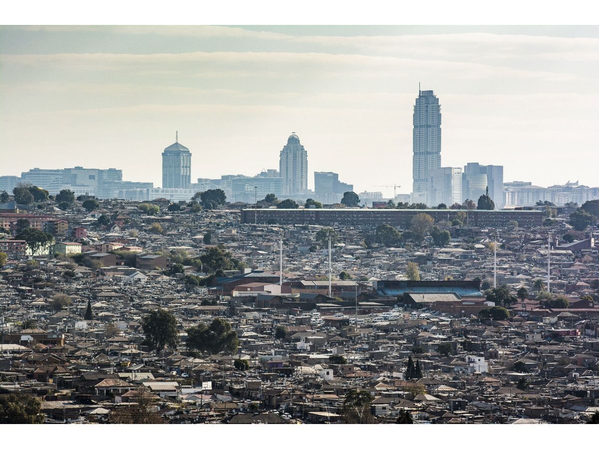 Skyscraper office buildings in Sandton beyond Alexandra township in Johannesburg, South Africa.